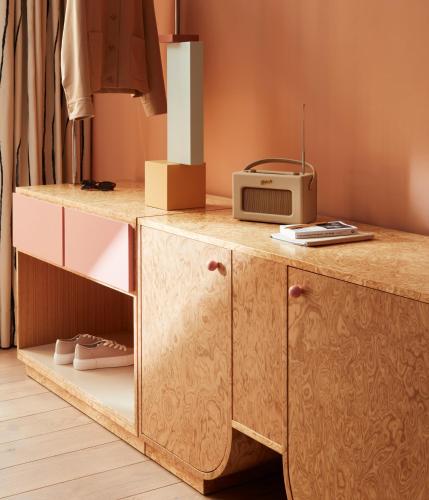 a wooden cabinet with a microwave on top of it at The Hoxton, Florence in Florence