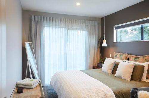 a bedroom with a large bed and a window at Bobs Cove Nature Getaway and spa in Mount Creighton
