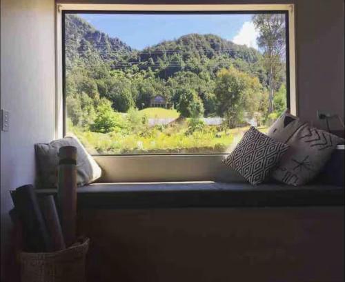 a window sill with a view of a mountain at Bobs Cove Nature Getaway and spa in Mount Creighton