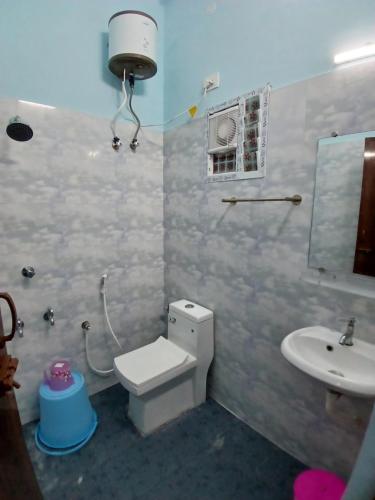 a bathroom with a toilet and a sink at Veera Residency Gingee in Gingee