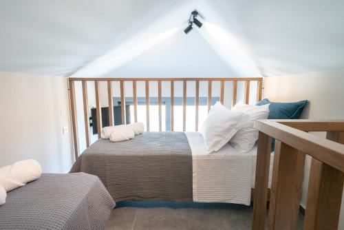 a bedroom with two beds with pillows on them at Aithra Lemnos in Thános