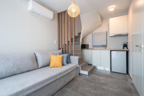 a living room with a couch and a kitchen at Aithra Lemnos in Thános