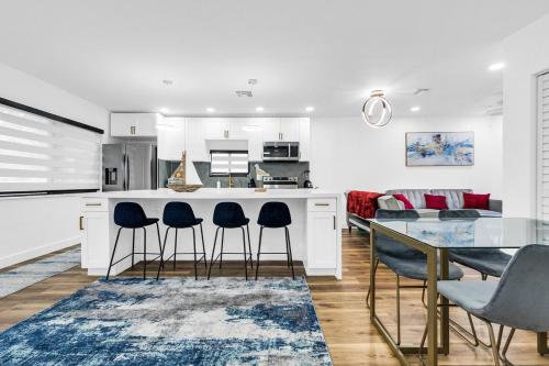 a kitchen and dining room with a table and chairs at Modern Home with large private yard - Next to downtown & beach & airport - Pet friendly in Fort Lauderdale