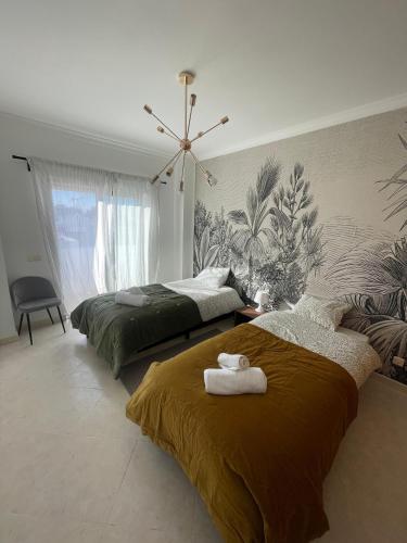 a bedroom with two beds with towels on them at Casa da Sofia by Rosado in Olhão