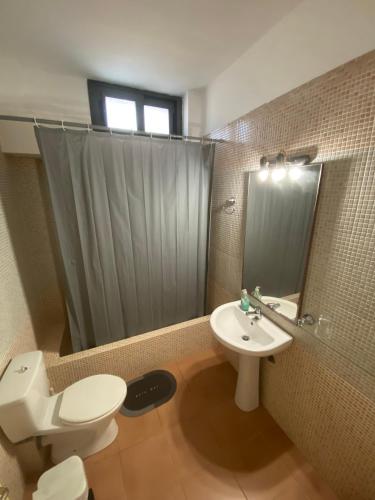 a bathroom with a white toilet and a sink at Villa Niobe in Riglia