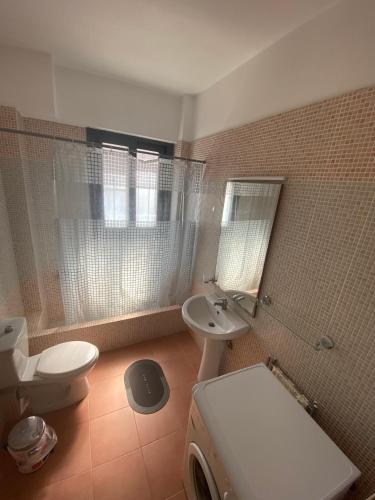 a bathroom with a white toilet and a sink at Villa Niobe in Riglia