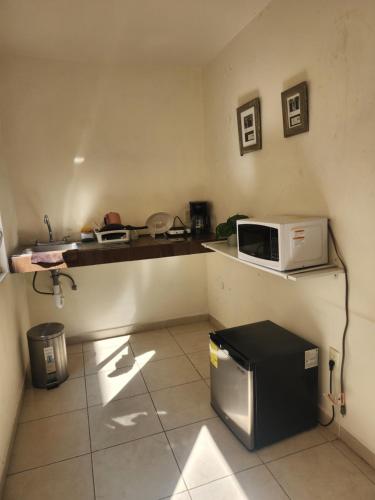 a small kitchen with a microwave on a counter at Loft en ciudad de Puebla in Puebla
