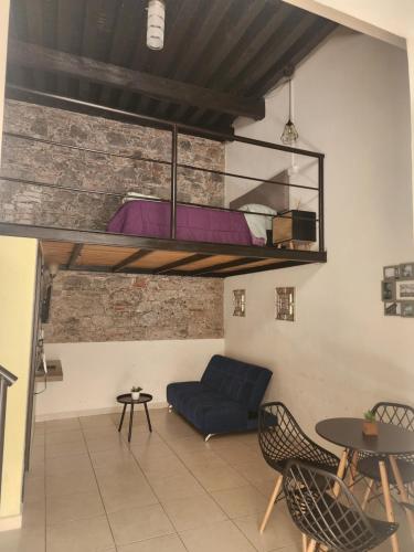 a living room with a couch and a bunk bed at Loft en ciudad de Puebla in Puebla