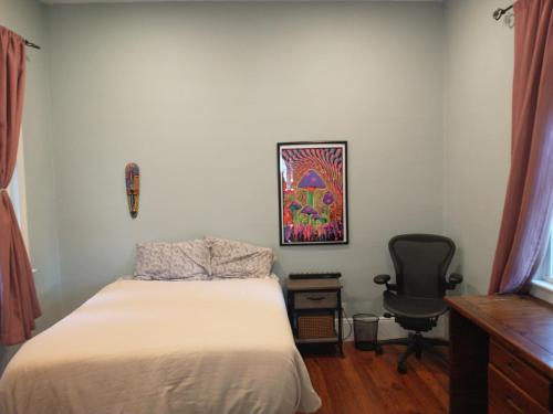 a bedroom with a bed and a desk and a chair at 2 Bedroom Unit and Big Yard 30 Minutes to NY in Ridgefield Park