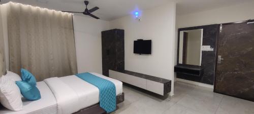 a bedroom with a bed and a tv in it at Balaji residency velankanni in Velankanni