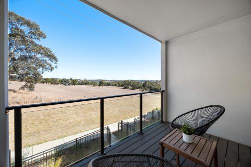 a balcony with two chairs and a view of a field at Olive Lane at Mount Barker Workspace, Wi-Fi in Mount Barker