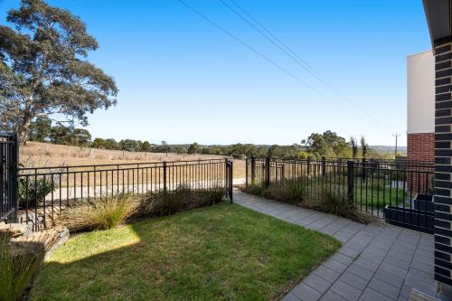 a fence and a walkway in a yard at Olive Lane at Mount Barker Workspace, Wi-Fi in Mount Barker