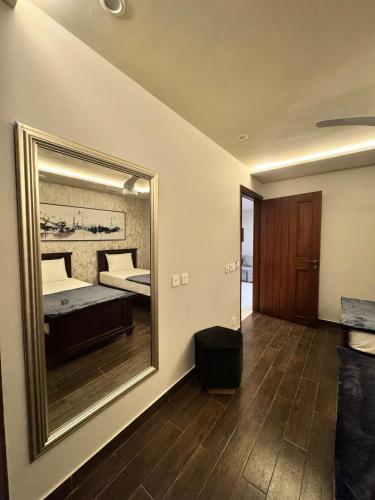 a bedroom with a large mirror and a bed at 2 Bed Apartment near Gulberg by Lux Haven Stays in Lahore