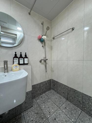 a bathroom with a shower and a sink at SeogyoHueStay in Seoul