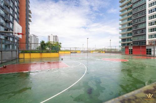 a basketball court is covered in water in a city at 3BR Serene Stay in North of Petaling Jaya near MRT station in Petaling Jaya