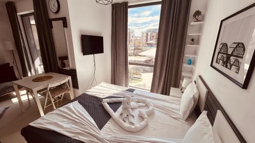 a bedroom with a bed with a large window at Rainbow 3-213 Large Studio Delux in Sunny Beach