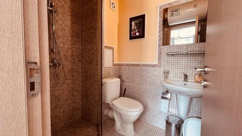 a bathroom with a toilet and a sink at Rainbow 3-213 Large Studio Delux in Sunny Beach