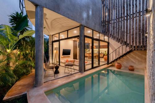 a house with a swimming pool and a living room at Bohemian Bliss Villa with Private Pool & Concierge 1A in Tulum