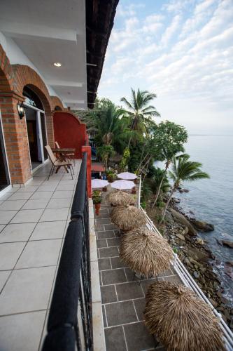 a balcony of a house with a view of the ocean at Traditional Sierra Leon Oceanfront Rooms - Adults Only in Puerto Vallarta