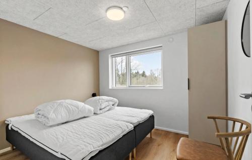 a bedroom with a bed and a window at Gorgeous Home In Hobro With Sauna in Hobro