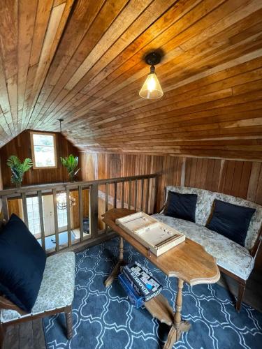 a living room with a couch and a table at Woodside Farm Country Inn in Sooke