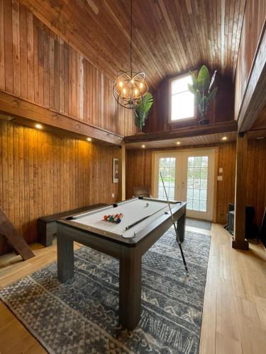 a large room with a pool table in it at Woodside Farm Country Inn in Sooke