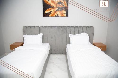 two beds sitting next to each other in a room at skoon rest hotel in Hafr Al Baten