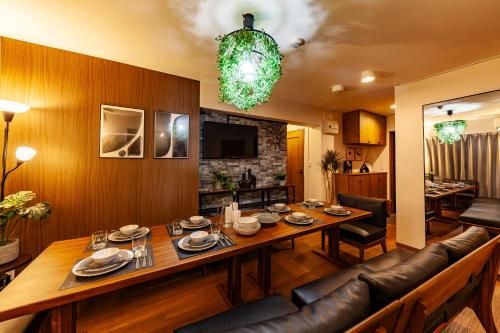 a dining room with a long table and a couch at Premier suite Shinjuku okubo Tokyo 3F in Tokyo