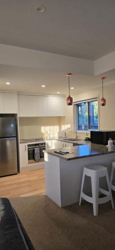 a kitchen with a large island in the middle at 3 Bedroom home in Palmerston North with BBQ and Sky Tv in Palmerston North