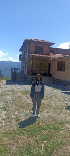 a person taking a picture in front of a house at Quinta las Marias, Ecolodge, camping y Tiny wood house in Guateque