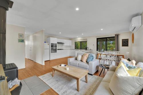 a living room with a couch and a table at Briar Rose Cottages in Stanthorpe