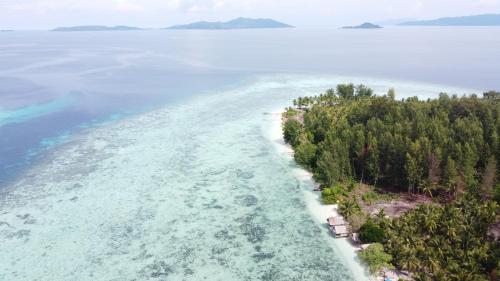 an aerial view of an island in the water at Coco Huts Guest House in Waisai