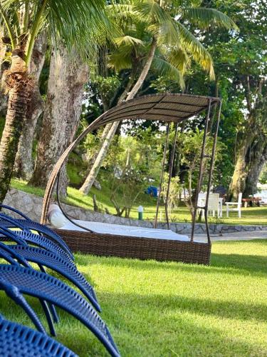 a park with a swing in the grass at Pousada Gipoia in Angra dos Reis