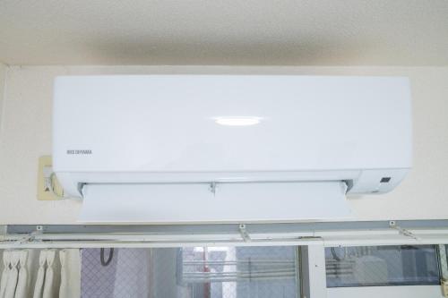 a white light above a window in a room at Minami-Fukuoka Good Place House in Fukuoka