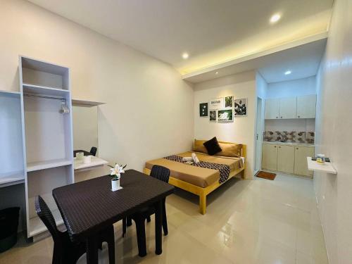 a room with a bed and a table and a couch at ZV Homes in Tagbilaran City