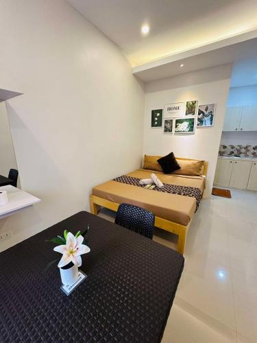 a room with two beds and a table with a flower on it at ZV Homes in Tagbilaran City