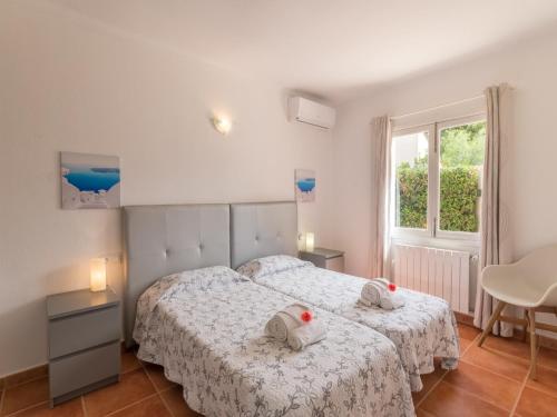 a bedroom with two beds and a window at Holiday Home Bona Mar with Pool in Cala Ratjada