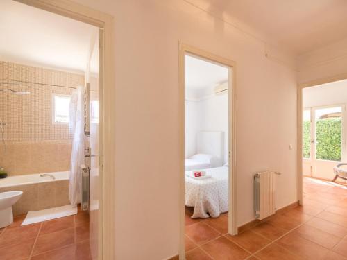 a bathroom with a tub and a toilet and a sink at Holiday Home Bona Mar with Pool in Cala Ratjada