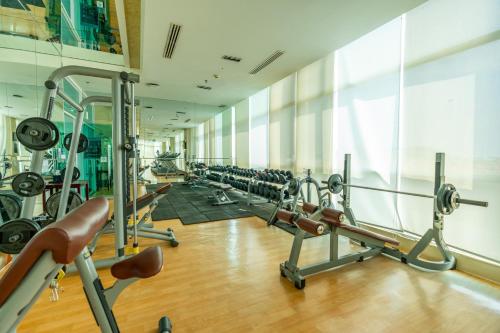 a gym with a row of tread machines at Dara Airport Hotel in Phnom Penh