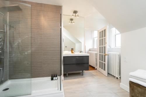 a bathroom with a shower and a sink at No. 5 East in Winnipeg