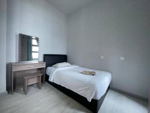 a bedroom with a bed and a dresser and a mirror at Jesselton Quay by Pinstay in Kota Kinabalu