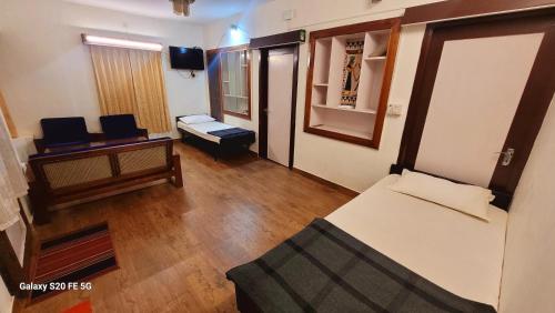 an overhead view of a room with a bed and a tv at Green Woods Homestay in Kodaikānāl