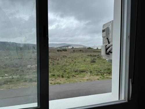 a window with a view of a field and a road at Ali Vista Vactions in Daidatz