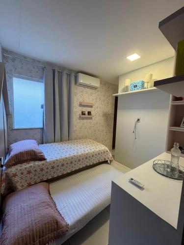 a bedroom with two beds and a counter at Casa de Praia - Ipitanga in Lauro de Freitas