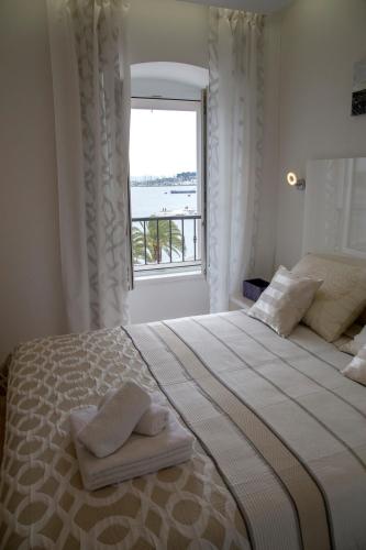 a bedroom with a large bed with a window at Luxury rooms Skystar-Split in Split