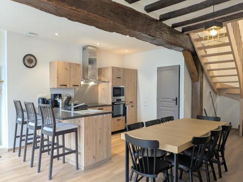 une cuisine et une salle à manger avec une table et des chaises en bois dans l'établissement Évasion moderne proche du Château de Valençay - FR-1-591-726, à Valençay