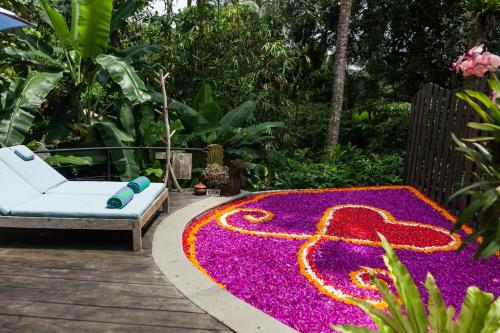 a garden with a carpet of purple and pink flowers at Sacred Beji by GenuineHost in Payangan