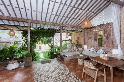 an outdoor living room with a couch and a table at Sacred Beji by GenuineHost in Payangan