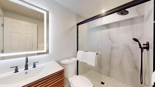 a bathroom with a shower and a toilet and a sink at The Cape in Cape May