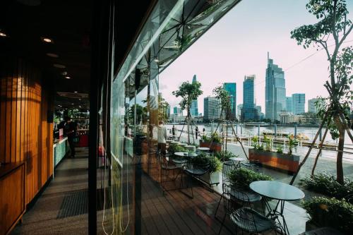 a balcony of a restaurant with a view of the city at Metropole Square Apartment Cental Saigon in Ho Chi Minh City
